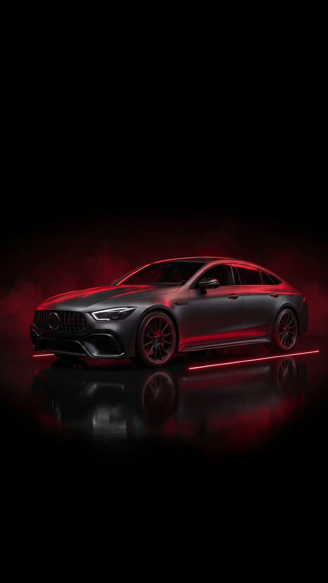 A car being serviced on site under red studio lighting